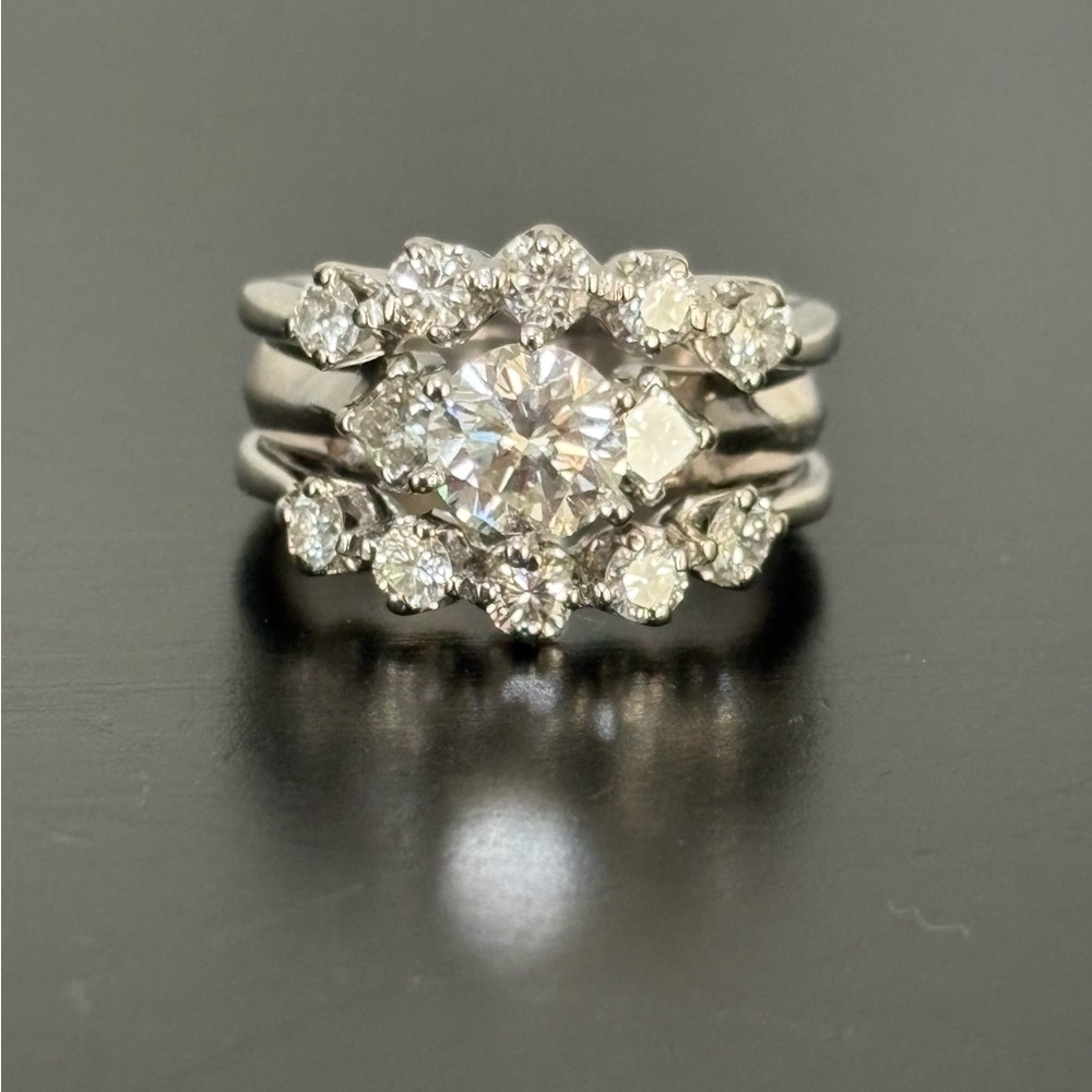Platinum ring with a 1 ct. center diamond set in 14 ct white gold diamond bands